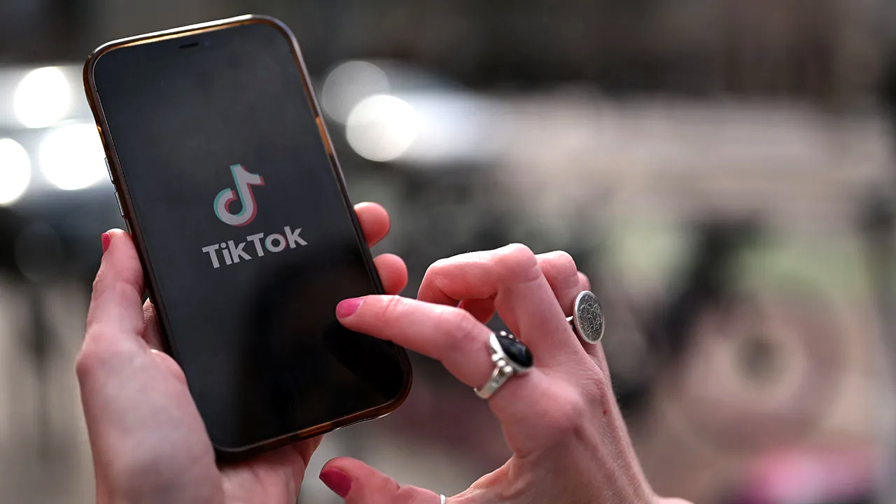 TechDogs-"An Image Of TikTok's Logo On A Phone In A User's Hand"