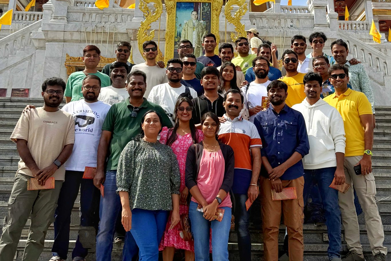 TechDogs-"Presentations.ai Team Posing On Temple Steps, With Sumanth Raghavendra On The Far Right In The Second Row Wearing A Green Shirt"