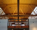 Preview of 415 Westlake - Image 0: historic, timber roof, exposed beams, skylights, industrial, structure wood, wood ceiling, trusses, modern, natural light, open space, mezzanine, black steel, interior architecture, ceiling design, structural design, contemporary, architectural details, minimalist.