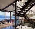 Preview of 56 Piles - Image 11: Couch, Furniture, staircase, structural steel, concrete floor.