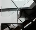 Preview of 56 Piles - Image 7: Dining Table, Furniture, Table, Banister, Handrail, Staircase, Triangle, Architecture, Building, Skylight, Window, steel detail, steel stair, glass interior.