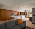 Preview of Ainslie Remodel and Addition - Image 4: kitchen, wood cabinetry, modern design, open concept, recessed lighting, island counter, hardwood floor, minimalist style, integrated appliances, white countertop, backsplash, contemporary furniture, indoor plants.