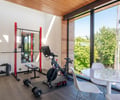Preview of Ainslie Remodel and Addition - Image 6: gym, fitness room, wood ceiling, large windows, natural light, home gym, hardwood floor, open space, modern design.