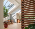 Preview of Ainslie Remodel and Addition - Image 3: skylight, wood slats, indoor plants, natural light, dining area, wooden flooring, open space, modern design, interior partition, light wood, concrete wall.