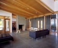 Preview of Bruckner Residence - Image 0: Couch, Furniture, Flooring, Indoors, Interior Design, Room, concrete wall, structure wood, concrete floor, wood ceiling, fireplace.