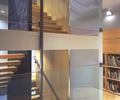 Preview of Cascades Lakehouse - Image 8: Dining Table, Furniture, Table, Light Fixture, Cd Player, Electronics, Bench, staircase, chalkboard, interior glass, wood wall.
