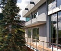 Preview of Casper Residence - Image 2: Roland Terry, historic, modern, contemporary, cantilever, deck, structure steel, large windows, glass facade, wooden deck, railing, sustainable, green building, urban, exterior, multi-story, flat roof, siding, clerestory windows, light grey, suburban, natural light, tree.