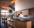 Preview of Eaton Residence - Image 11: Chair, Furniture, Indoors, Interior Design, Kitchen, Dining Table, Table, Banister, Handrail, Staircase, Wood ceiling, Concrete floor, Glass exterior.