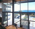 Preview of Eaton Residence - Image 13: Dining Table, Furniture, Table, Indoors, Room, Plywood, Wood, Chair, Dining Room, Interior Design, Indoor, Waterfront, Concrete floor, Structure steel.