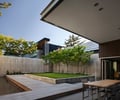 Preview of Graham Residence - Image 16: Dining Table, Furniture, Table, Backyard, Outdoors, Yard, Courtyard Wood floor, Wood wall, Concrete wall.