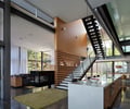 Preview of Graham Residence - Image 17: Great room, Appliance, Oven, Banister, Handrail, Staircase, Indoors, Interior Design, Kitchen, Room, Apartment, Building, Housing, Loft, Indoor, Wood wall, Concrete floor, Structure steel.