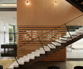 Preview of Graham Residence - Image 22: Dining Table, Furniture, Table, Wood wall, Stair, Concrete floor, Lighting, Fireplace.
