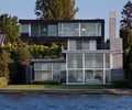 Preview of Graham Residence - Image 26: Cantilever, Building, Office Building, Flora, Jar, Plant, Potted Plant, Pottery, Vase, Fence, Hedge, Housing, Outdoor, Concrete wall, Glass exterior, Structure steel, waterfront.