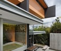 Preview of Graham Residence - Image 8: Backyard, Outdoors, Yard, Patio, Pergola, Porch, Building, Office Building, House, Housing, Villa, Outdoor, Glass exterior, Cantilever, Wood wall, Color, Concrete floor, Courtyard.