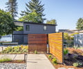 Preview of Vashon Island Cabin - Image 1: modern, contemporary, structure wood, structure concrete, courtyard, garden, wooden fence, slatted design, flat roof, large windows, paved pathway, landscaping, waterfront, urban, sustainable, green building, outdoor lighting, concrete floor, steel elements, geometric design.
