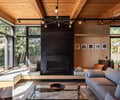 Preview of Vashon Island Cabin - Image 13: modern, living room, wood ceiling, black steel, glass table, large windows, built-in seating, wooden walls, minimalist, contemporary, cozy, natural light, recessed lighting, pendant lighting, neutral colors, seating area, indoor-outdoor connection.