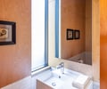 Preview of Vashon Island Cabin - Image 16: bathroom, modern, minimalist, wood paneling, tile wall, sink, mirror, natural light, frosted glass window, contemporary, small space design, sleek faucet, interior design, compact bathroom, light wood finish.