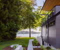 Preview of Vashon Island Cabin - Image 3: waterfront, modern, contemporary, structure concrete, structure wood, deck, glass railing, flat roof, siding, black steel, urban, landscape, walkway, outdoor space, sustainable, green building.