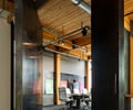 Preview of Intentional Futures - Image 0: Building, Housing, Indoors, Loft, Interior Design, Office, structrure wood, wood ceiling, exposed duct, concrete floor, steel pivot door, meeting space, heavy timber.