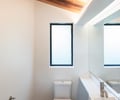 Preview of KITCHEN CONNECTED - Image 7: bathroom, wooden ceiling, frosted window, white walls, modern sink, integrated lighting, minimalist design, wall-mounted faucet, wood flooring, clean lines, compact space, natural light.