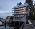 Preview of Lagerberg Mooring - Image 1: modern house, glass facade, metal siding, waterway, cantilever, railing, industrial design, elevated structure, waterfront, external stairs, contemporary architecture.