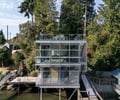 Preview of Lagerberg Mooring - Image 4: modern house, glass walls, metal structure, deck, railing, waterfront, cantilever, stairs, outdoor seating, multi-story, contemporary design, stilt house, water deck, glass balcony.