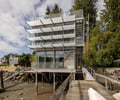 Preview of Lagerberg Mooring - Image 5: modern house, glass facade, metal structure, railing, deck, waterfront, stairs, outdoor terrace, large windows, cantilever, industrial design, pilotis, balcony.