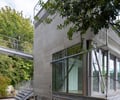 Preview of Lagerberg Mooring - Image 6: structure concrete, concrete wall, railing, bridge, glass windows, metal framework, exterior stairs, landscaped path, modern design.