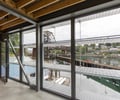 Preview of Lagerberg Mooring - Image 11: bridge, structure wood, concrete floor, windows, metal railing, exposed beams, waterfront, natural light, industrial design.