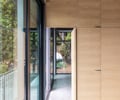 Preview of Lagerberg Mooring - Image 16: glass door, wood paneling, structure concrete, structure wood, concrete floor, large windows.
