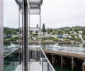 Preview of Lagerberg Mooring - Image 18: glass railing, metal structure, deck, waterfront, modern architecture, steel materials, reflective surface.