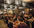 Preview of Mamnoon Restaurant - Image 4: People, Audience, Restaurant, Steel, Stainless Steel, Structure Steel, Exposed Structure, Concrete, Table, Dining, Dining Table, Sliding Partition, Glass, Kitchen, Wood, Wood Screen.