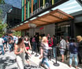 Preview of Mamnoon Street - Image 6: People, Dance, Steel, Concrete, Street, Storefront, Restaurant, Entry, Glass, Window, Wood.