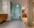 Preview of Market Condo - Image 13: Flooring, Plywood, Wood, master bath, tile floor, tile base, bar pull, shower, toilet room, etch matte glass, concrete column, Bathroom, Glass, Concrete, Pillar, Condominium, Interior Design, Indoors.