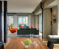 Preview of Market Condo - Image 2: Couch, Furniture, Indoors, Interior Design, concrete structure, exposed steel , wood floor, Great Room, Steel, Window, Glass, Daylight, Dining Table, Condominium, Wood.