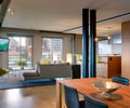 Preview of Market Condo - Image 3: Couch, Furniture, Dining Table, Indoors, Dining Room, Interior Design, exposed steel , wood floor, kitchen, cabinetry, wall mounted monitor,  tv, Steel , Glass, Concrete, Kitchen, Great Room, Condominium.