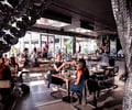 Preview of Mbar - Image 13: Human, Cafe, Chair, Furniture, Restaurant, Steel, Concrete, Glass, Window, Dining Table, Bar, Wood, Curtain, Daylight.
