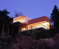 Preview of Mile Post 9 - Image 4: Cantilever, House, color, deck, steel railing, lighting, waterfront.