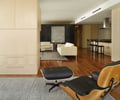 Preview of Millennium Tower Condo - Image 2: Chair, Furniture, Indoors, Room, Hardwood, Wood, Apartment, Building, Housing, Couch, Studio Couch, Dining Table, Table, wood floor, cabinetry, pulls, bar seating.