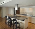 Preview of Millennium Tower Condo - Image 4: Flooring, Dining Table, Furniture, Table, Indoors, Interior Design, Kitchen, Room, Chair, bar seating, appliance garage, kitchen sink, wood floor.