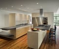Preview of Millennium Tower Condo - Image 6: Hardwood, Wood, Appliance, Electrical Device, Oven, Flooring, Dining Table, Furniture, Table, Home Decor, Linen, Tablecloth, Indoors, Interior Design, Chair, cantilever counter, cantilever, cabinetry, bar seating, hood, bar pulls.