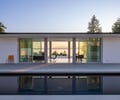 Preview of Northwest Reflections - Image 4: Roland Terry, modern architecture, glass facade, floor-to-ceiling windows, minimalist design, flat roof, concrete, outdoor patio, reflection pool, open plan, sliding doors, landscape view, natural light, modernist style, clean lines, concrete floor.
