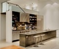 Preview of Open House - Image 1: Indoors, Interior Design, Kitchen, Room, Furniture, bar stools, concrete, open shelves, stainless steel, hood, steel handrail, glass guardrail.