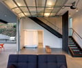 Preview of Open House - Image 16: Banister, Handrail, Staircase, Chair, Furniture, Couch, Indoors, Interior Design, Dining Table, Table, projector screen, bed, concrete floor, stair infill, steel stair, barbecue, garage door.