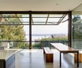 Preview of Open House - Image 8: Great room, Dining Table, Furniture, Table, Indoors, Bench, concrete floor, steel structure, garage door, glass exterior .