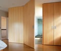 Preview of Petersen Residence - Image 3: Hardwood, Wood, Door, Sliding Door, master bath, pivot door, wood cabinet, recessed pull.
