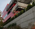 Preview of Shapiro Residence - Image 2: Tomb, Apartment Building, Building, City, High Rise, Town, Urban, Concrete wall, cantilever, Retaining wall, Red, Structure steel.