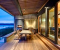 Preview of South Whidbey Residence - Image 0: Deck, Hardwood, Wood, Furniture, Indoor Outdoor, Glass Door, Waterfront, Grill, Patio, Wood floor, Concrete table, Slab, Barbecue, Outdoor, Framing steel, Sliding door, Kitchen, Lighting.