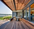 Preview of South Whidbey Residence - Image 1: Deck, Furniture, Grill, Indoor Outdoor, Hardwood, Wood, Glass Door, Waterfront, Patio, Sliding door, Slab, outdoor dining.