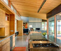 Preview of South Whidbey Residence - Image 10: Furniture, Indoors, Interior Design, Wood, Kitchen, Appliances, Concrete, Fireplace, Glass Door, Glass, Great Room, Dining Room, Sink, Sliding door, Cabinet.